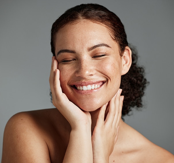 Face, beauty and satisfaction with a model black woman in studio on a gray background to promote natural skincare. Facial, wellness and makeup with an attractive young female happy with cosmetics