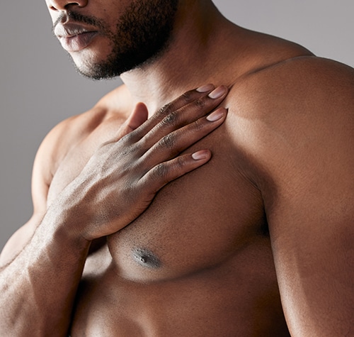 Studio shot of a unrecognizable muscular man posing against a grey background